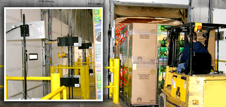 fork truck putting boxes on truck going past rfid scanners at dock doors